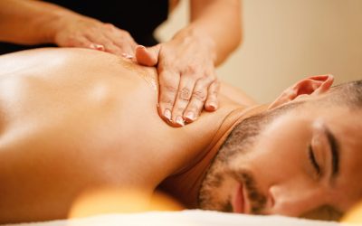 Close-up of man enjoying in relaxing back massage with honey at the spa.